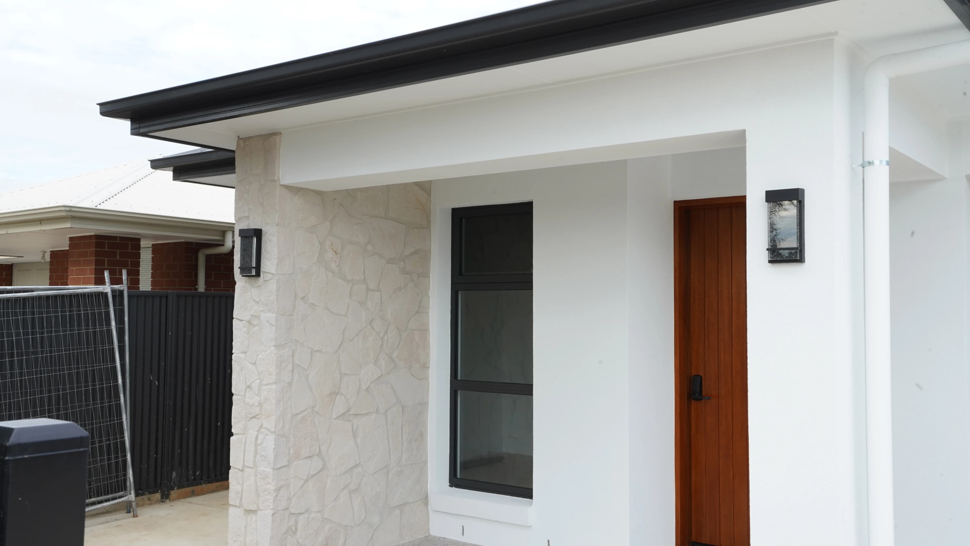 Angled entry view with stone cladding and timber door
