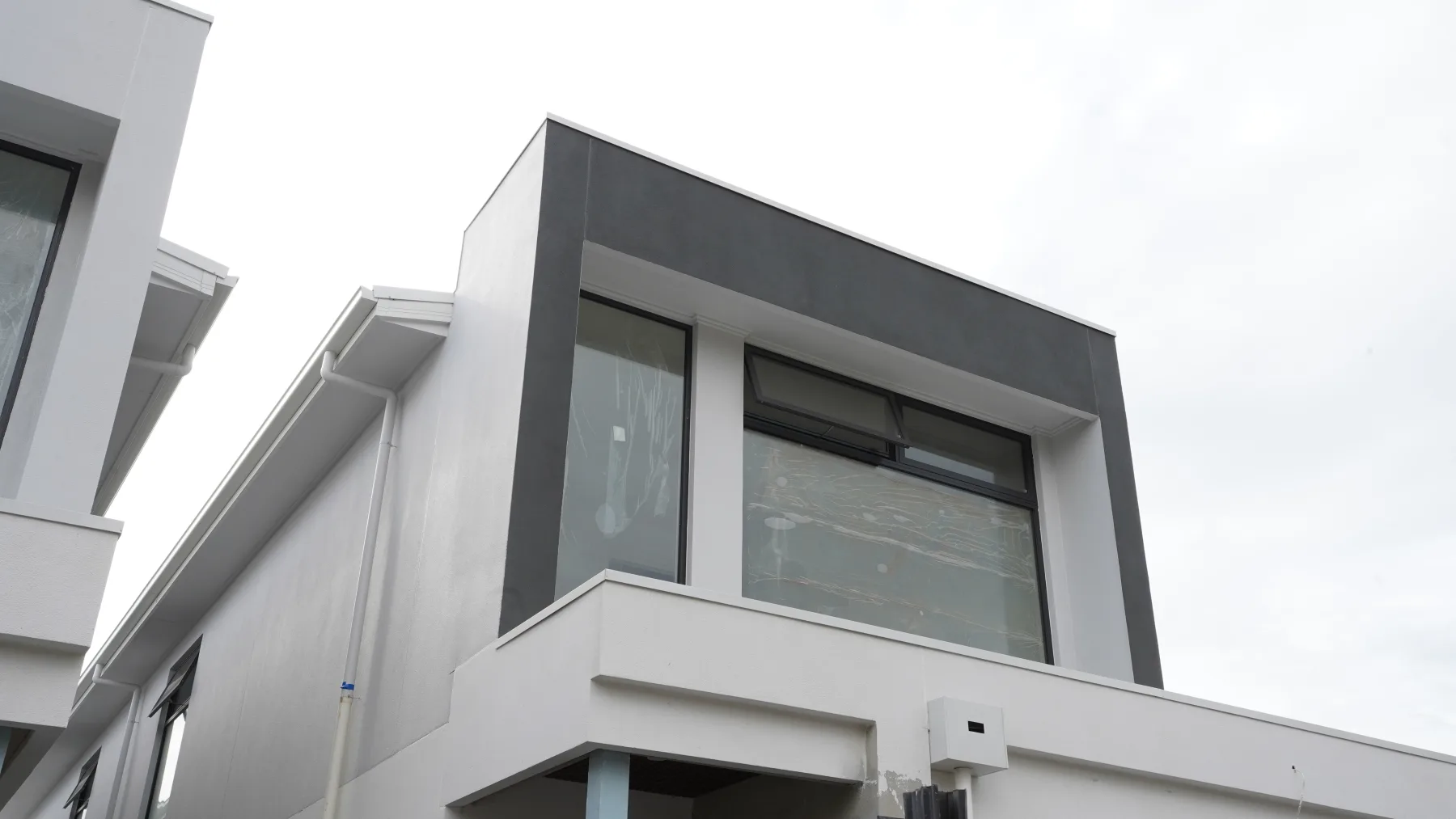 Angled facade view of feature glazing and dark aluminium frames