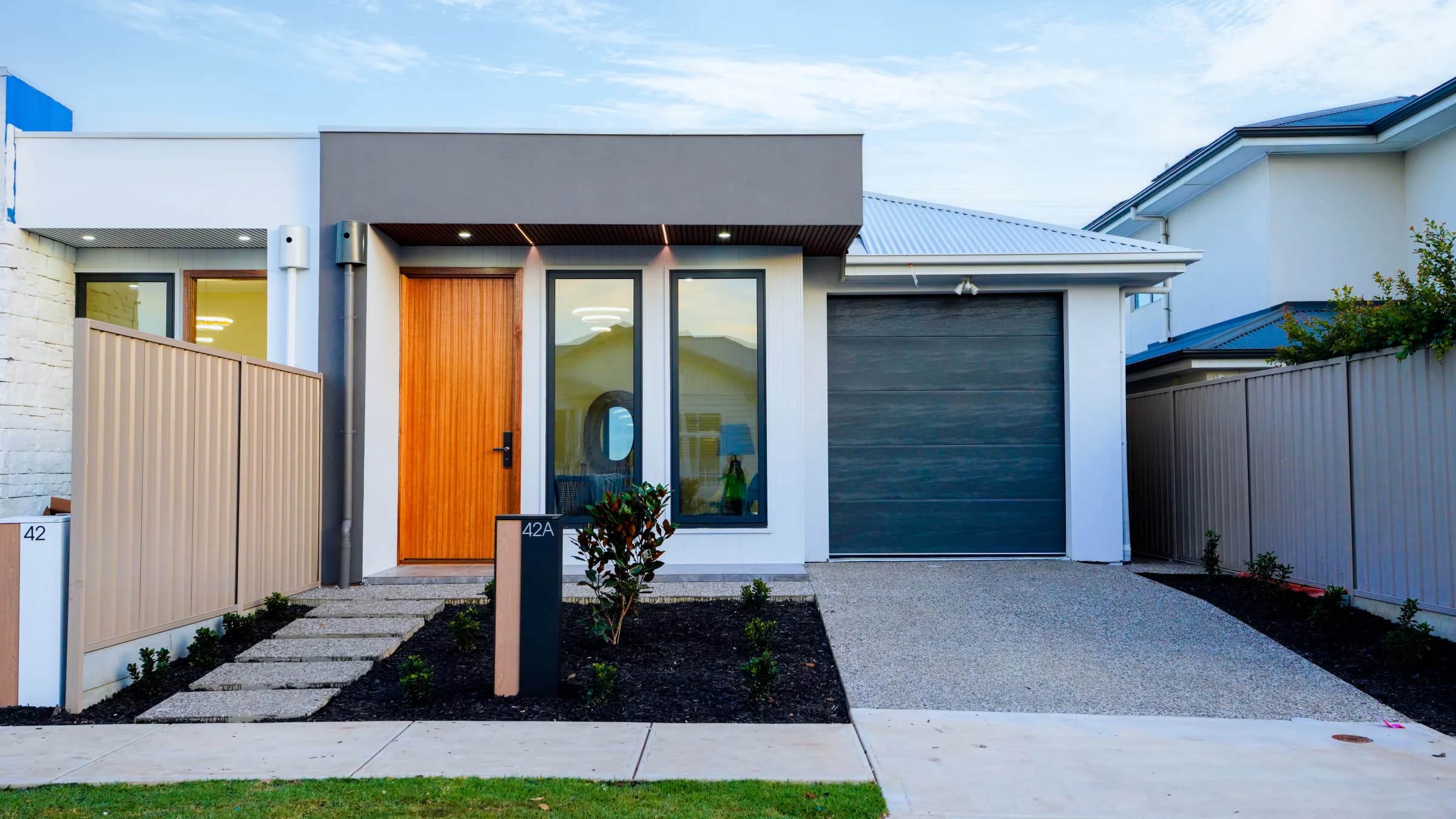 Contemporary Glengowrie residence with front fixed windows and timber entry door